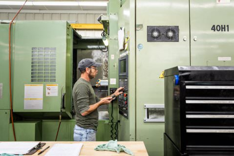 Machinist operating CNC equipment on the Knox Machine shop floor